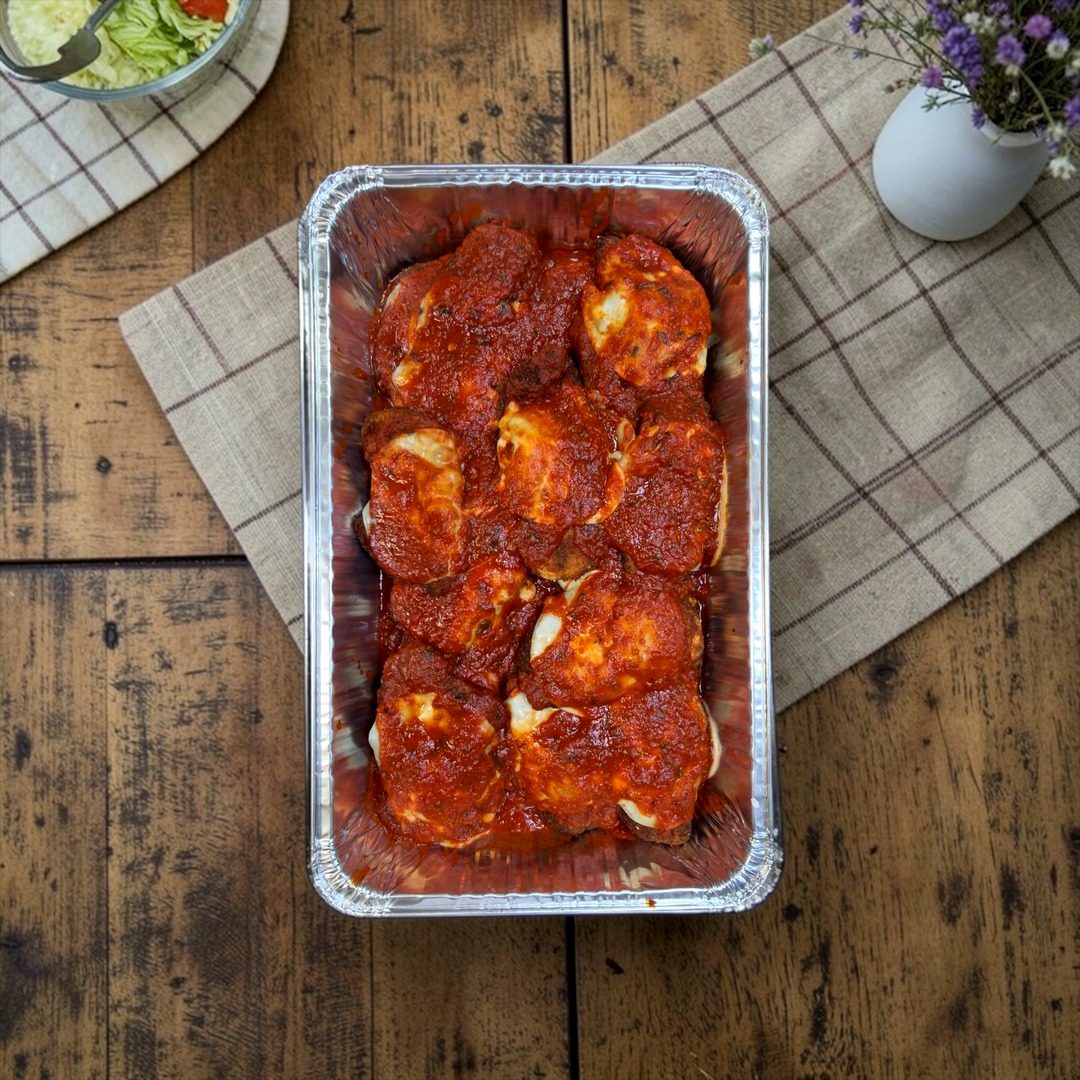 Catering tray of chicken parmesan in red sauce