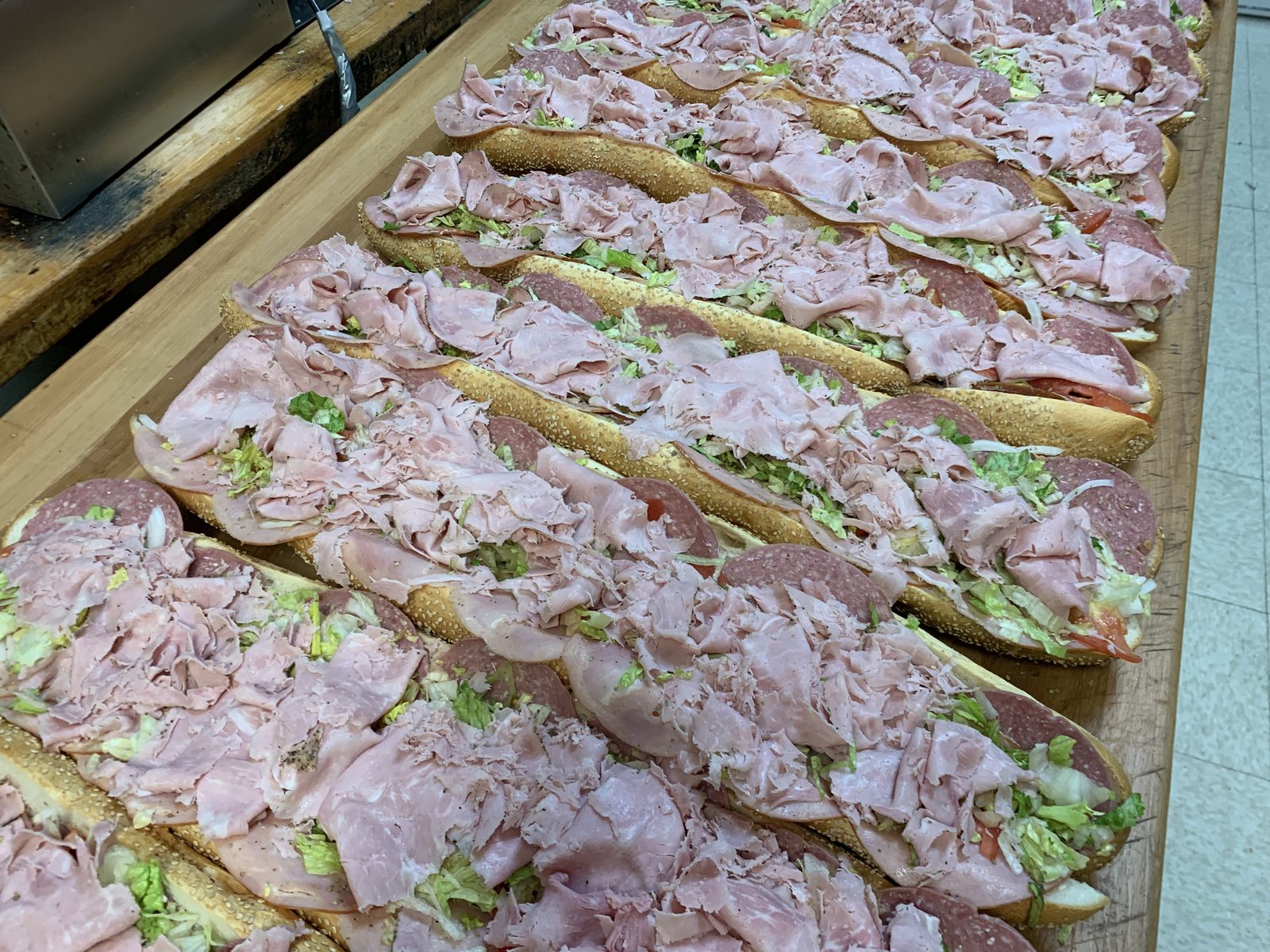 Row of fresh Italian hoagies prepared for catering