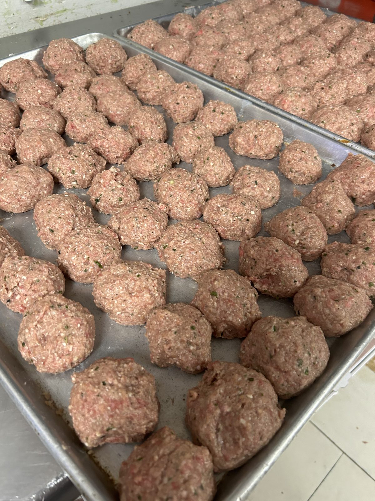 Trays of fresh hand-rolled Italian meatballs