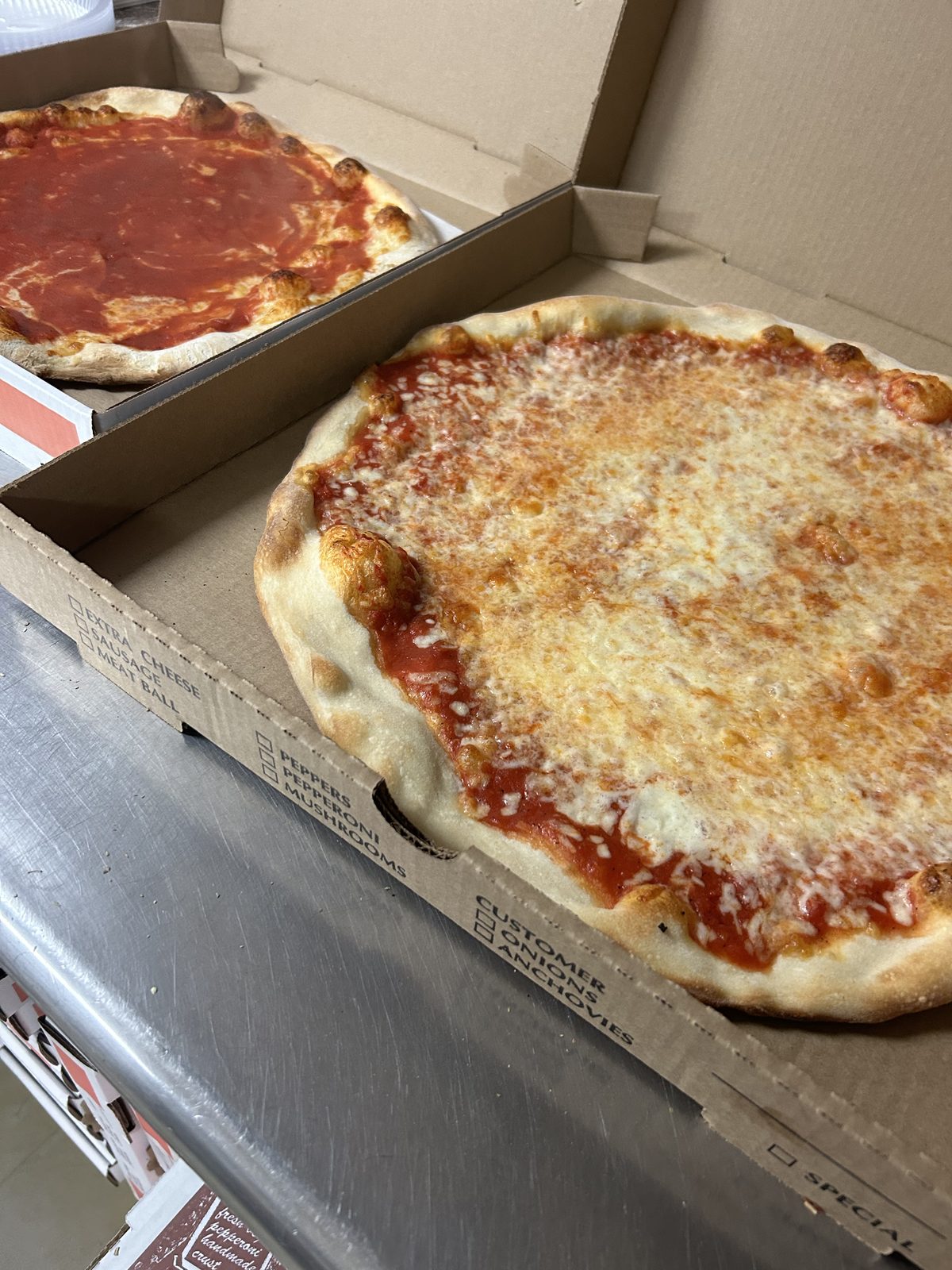 Fresh hand-tossed pizzas with cheese and tomato sauce